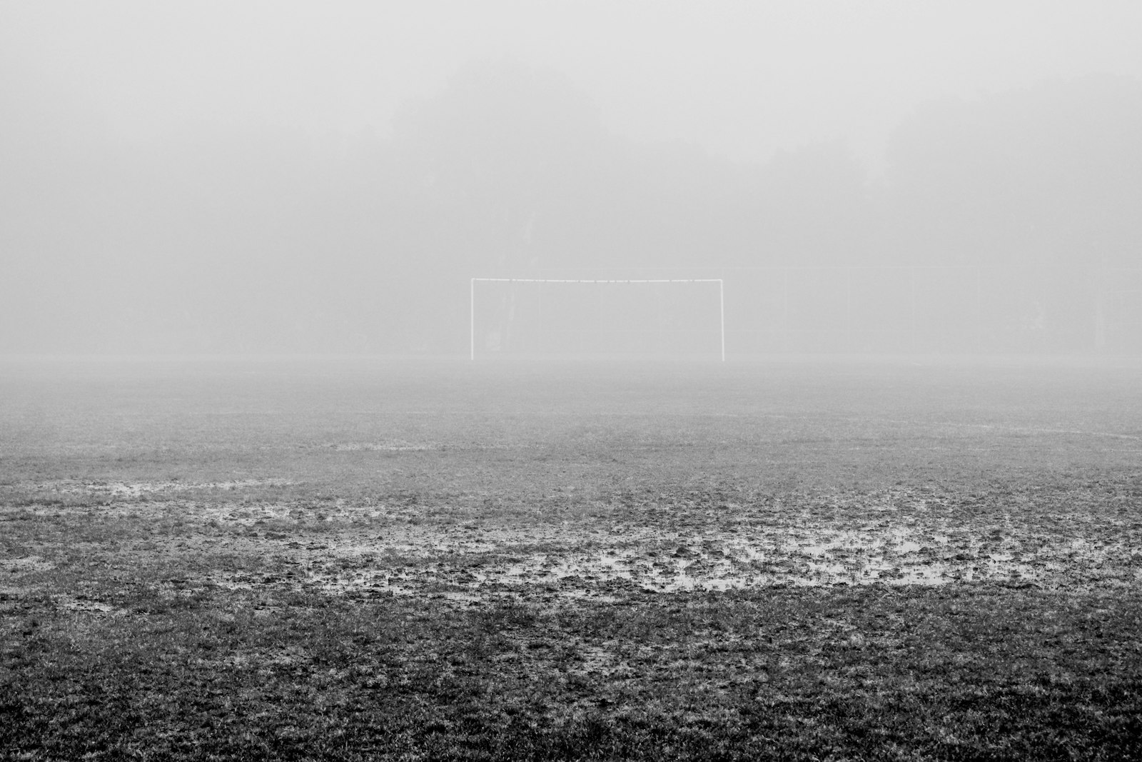 試合が中止になった日の霧に包まれたサッカーゴール